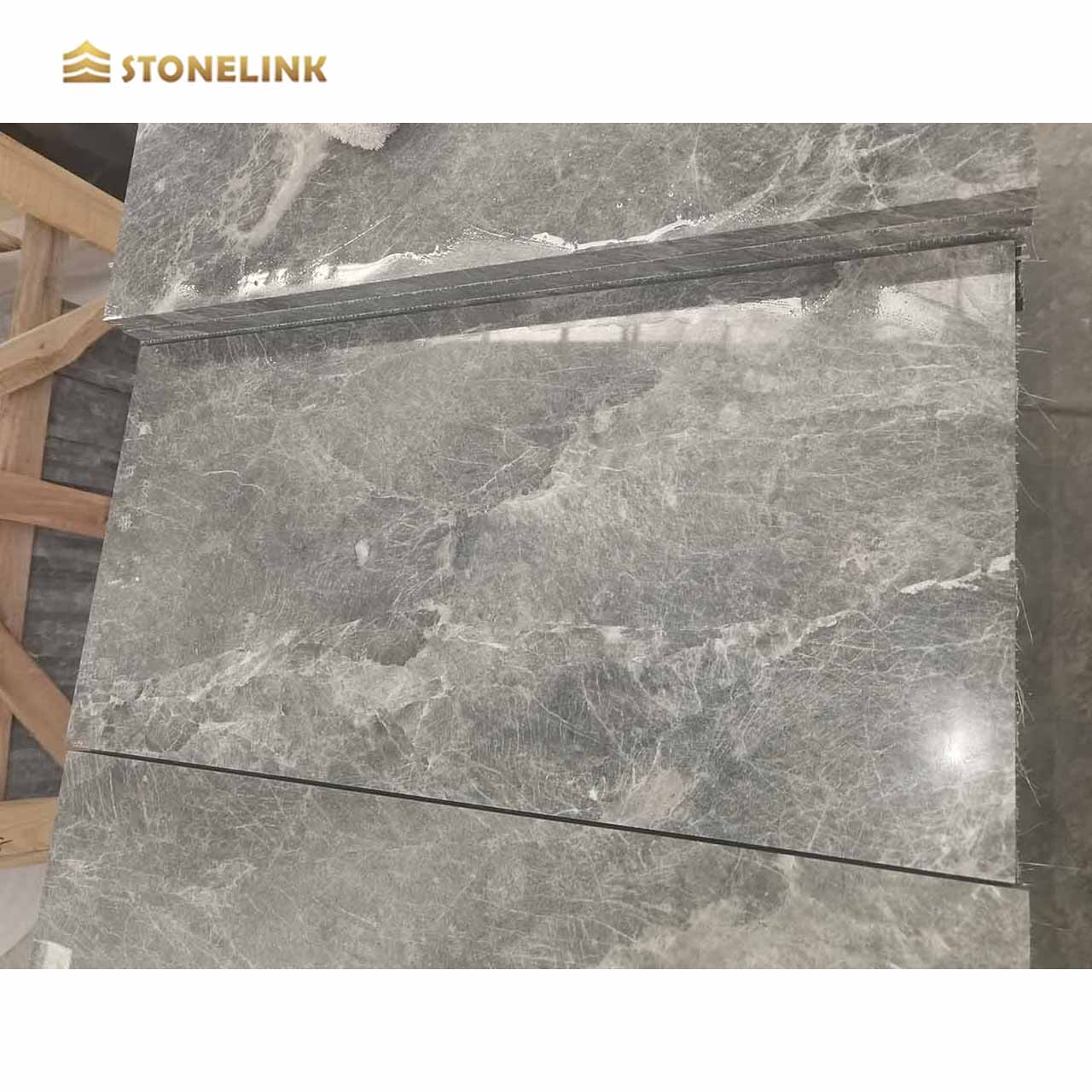 How does the durability of marble tiles compare to other popular tile materials like ceramic or porcelain?